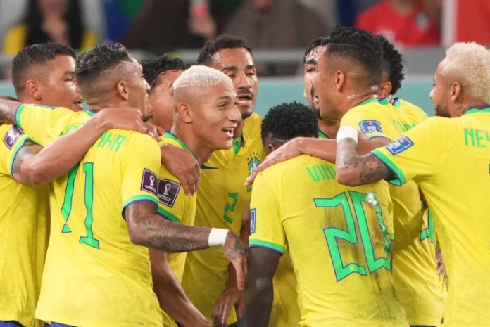 Brazil celebrating their third goal, with goalscorer Richarlison in the centre [Sorin Furcoi/Al Jazeera]