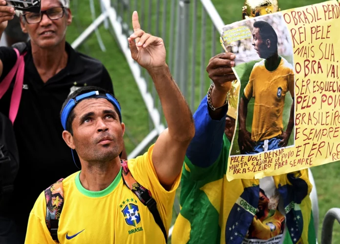 People line up to pay their last respects to the late Brazilian great Pele during his wake. [Matias Delacroix/AP Photo]