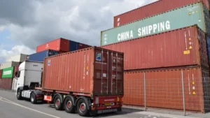 A truck drives past containers piled up at the German port in Duisburg in June. Sam Reeves/AFP/Getty Images