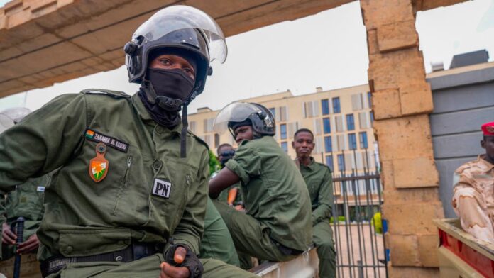 Nigerien police officers sit outside the customs offices in Niamey, Niger, on August 21, 2023. (AP)