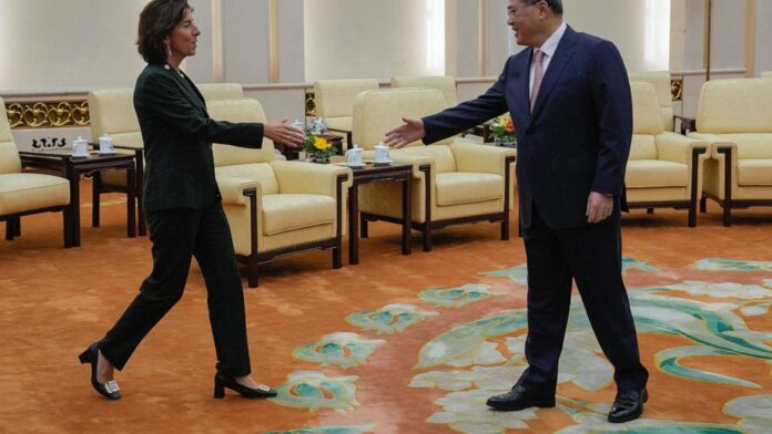 U.S. Commerce Secretary Gina Raimondo, left, greets Chinese Premier Li Qiang at the Great Hall of the People in Beijing, Tuesday, Aug. 29, 2023. (AP Photo/Andy Wong, Pool)