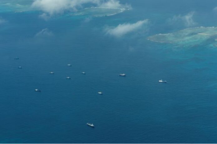 An aerial view of what Philippine Coast Guard alleges were Chinese vessels, manned by Chinese maritime militia loitering within the vicinity of Thitu Island, one of nine features occupied by the Philippines in Spratly Islands, in the disputed South China Sea, March 9, 2023/File Photo