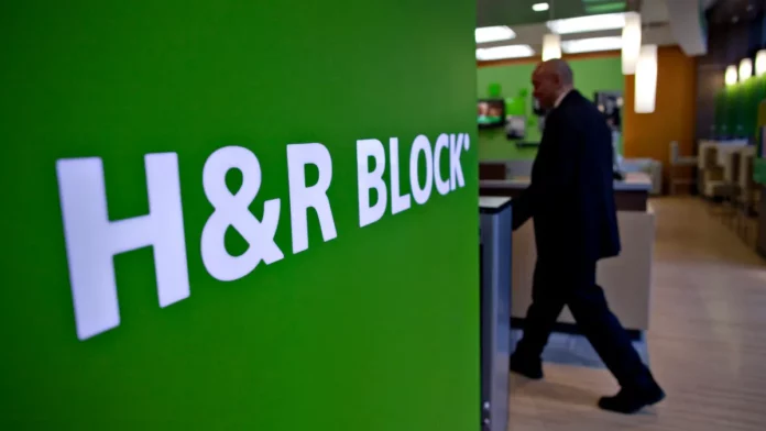 FILE – An H&R Block logo hangs in an H&R Block office in New York, U.S., on Monday, March 8, 2010.