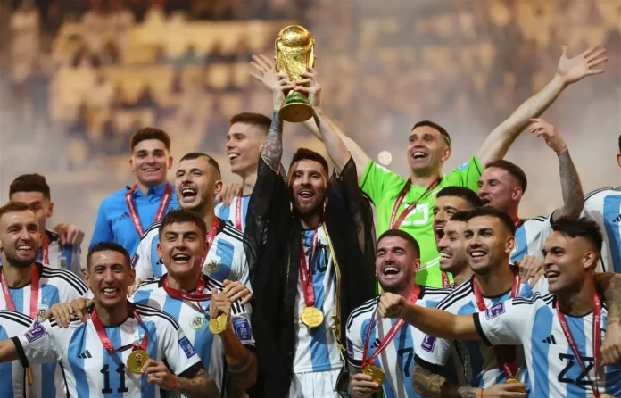 Soccer Football – FIFA World Cup Qatar 2022 – Final – Argentina v France – Lusail Stadium, Lusail, Qatar – December 18, 2022 Argentina’s Lionel Messi lifts the World Cup trophy alongside teammates as they celebrate winning the World Cup REUTERS/Carl Recine