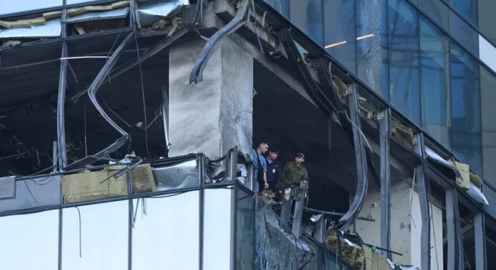 Investigators examine a damaged skyscraper in Moscow's business district after a reported drone attack on July 30.AP Photo