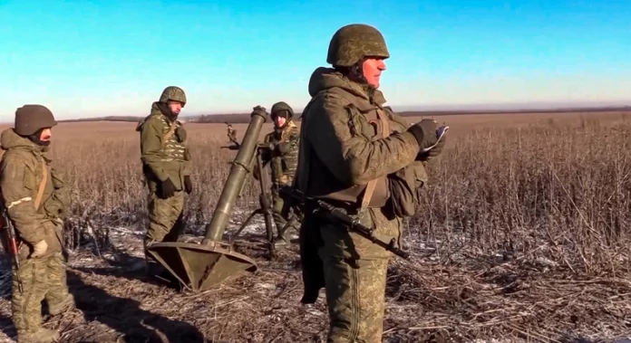 In this handout photo taken from video released by Russian Defense Ministry Press Service on January 13, 2023, Russian soldiers prepare to fire at an undisclosed location in Ukraine.Russian Defense Ministry Press Service via AP