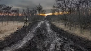 A soldier from a Ukrainian assault brigade walks on a muddy road used to transport and position British-made L118 105 mm Howitzers, on March 4, 2023, near Bakhmut, Ukraine.     John Moore | Getty Images News | Getty Images