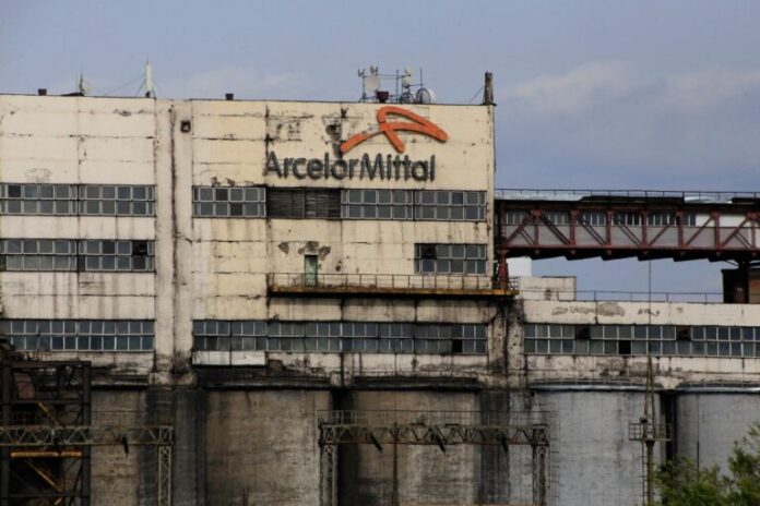 (FILES) The logo of ArcelorMittal, a Western steel giant which entered the Kazakh market after the Soviet collapse, is seen on a mine building in the industrial town of Shakhtinsk on September 9, 2023. (Photo by Ruslan PRYANIKOV / AFP)