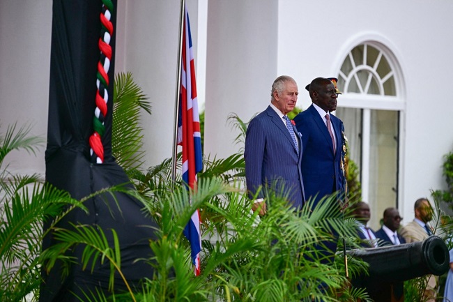 Britain’s King Charles III (L) is welcomed by Kenyan President William Ruto (R) during the ceremonial welcome at the State House in Nairobi on October 31, 2023.  (Photo by Ben Stansall / AFP)