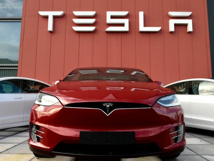 A Tesla car is displayed at a showroom and service center for the auto maker in Amsterdam on Oct. 23, 2019. Tesla recently cut prices across the board, a move with big potential ramifications for the automaker as well as for the industry. John Thys/AFP via Getty Images