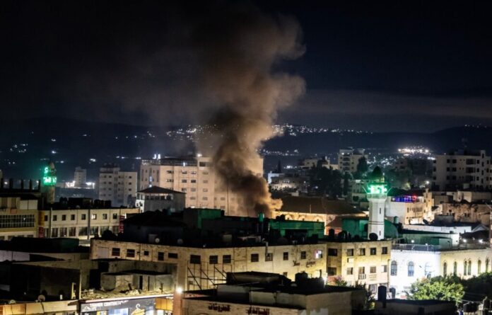 Smoke raises during an Israeli raid in the occupied West Bank Jenin refugee camp on November 16, 2023. (Photo by FADEL SENNA / AFP)