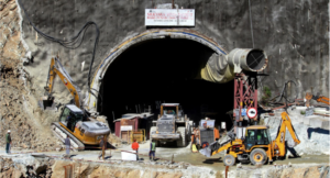 Rescue workers stand at an entrance of the under construction road tunnel, days after it collapsed in the Uttarkashi district of India’s Uttarakhand state on November 18, 2023. Indian rescuers said on November 18, they had paused efforts to reach 41 men trapped in a collapsed road tunnel after a cracking sound created a “panic situation” over the possibility of a further cave-in. (Photo by AFP)