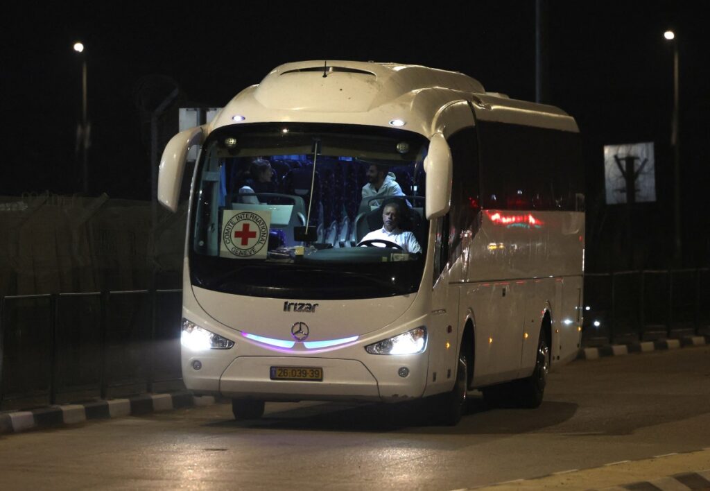   A Red Cross bus and delegation arrive outside the Israeli Ofer military prison located between Ramallah and Beitunia in the occupied West Bank on November 30, 2023, ahead of the release of Palestinians in exchange for Israeli hostages held by Hamas in Gaza since the October 7 attacks. (Photo by AHMAD GHARABLI / AFP