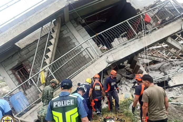 Emergency crew searching through a collapsed building in La Trinidad on July 27, 2022. PHOTO: REUTERS
