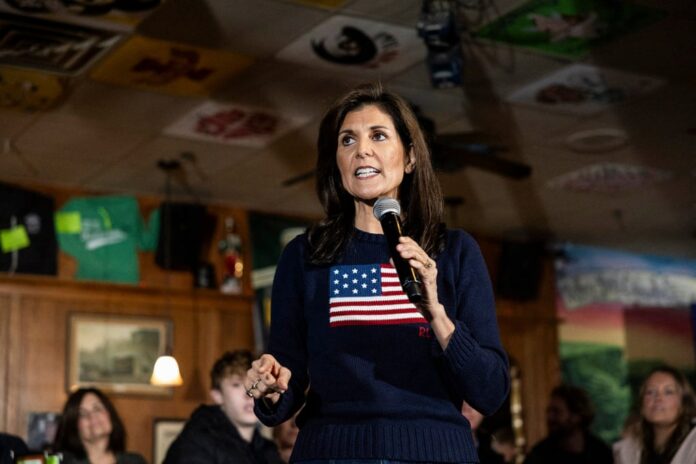A woman wearing a sweater with an American flag on it speaks into a microphoneShow captionNikki Haley at a campaign stop in Waukee, Iowa, before the Iowa caucuses next week. Photograph: Christian Monterrosa/AFP via Getty Images