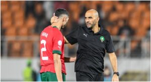 Morocco’s coach Walid Regragui (R) and Morocco’s defender #2 Achraf Hakimi (L) react after their loss in the Africa Cup of Nations (CAN) 2024 round of 16 football match between Morocco and South Africa at the Stade Laurent Pokou in San Pedro on January 30, 2024. (Photo by SIA KAMBOU / AFP)