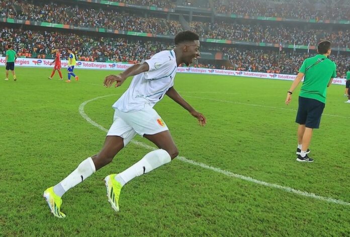 Guinea’s midfielder #11 Mohamed Bayo celebrates scoring his team’s first goal during the Africa Cup of Nations (CAN) 2024 round of 16 football match between Equatorial Guinea and Guinea at the Alassane Ouattara Stadium in Ebimpe, Abidjan, on January 28, 2024.