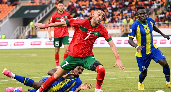 Morocco’s midfielder #7 Hakim Ziyach (C) fights for the ball with Tanzania’s defender #4 Ibrahim Hamad (DOWN) during the Africa Cup of Nations (CAN) 2024 group F football match between Morocco and Tanzania at Stade Laurent Pokou in San Pedro on January 17, 2024. (Photo by SIA KAMBOU / AFP)