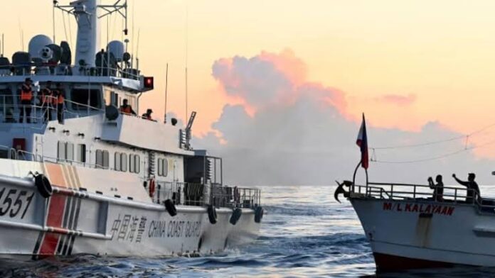 Chinese Coast Guard vessel on the left blocks a chartered supply boat on a mission to deliver provisions to a grounded Philippine Navy vessel at Second Thomas Shoal in the South China Sea. (Photo: AFP/Jam Sta Rosa)