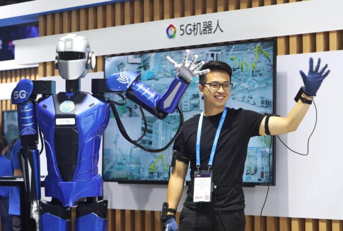 A worker interacts with a robot of robotics startup Roborn Dynamics Ltd in Shanghai.Visual China Group via Getty Images