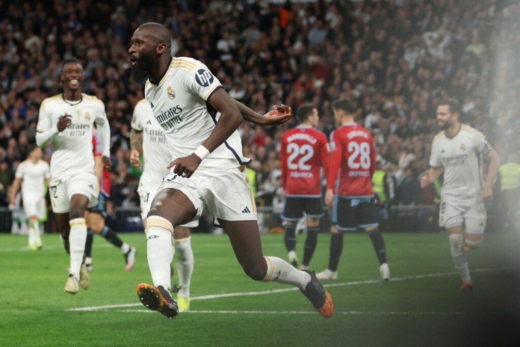 Real Madrid’s German defender #22 Antonio Rudiger celebrates Celta’s owngoal during the Spanish league football match between Real Madrid CF and RC Celta de Vigo at the Santiago Bernabeu stadium in Madrid on March 10, 2024. (Photo by Pierre-Philippe MARCOU / AFP)