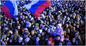 People attend a rally and a concert celebrating the 10th anniversary of Russia’s annexation of Crimea at Red Square in Moscow on March 18, 2024. (Photo by NATALIA KOLESNIKOVA / AFP)