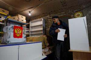 Local resident Sergey casts his vote into a mobile ballot box in the basement of a destroyed apartment building in the town of Avdiivka in Russian-controlled Donetsk Region, during Russia's presidential election on March 16, 2024. (REUTERS)