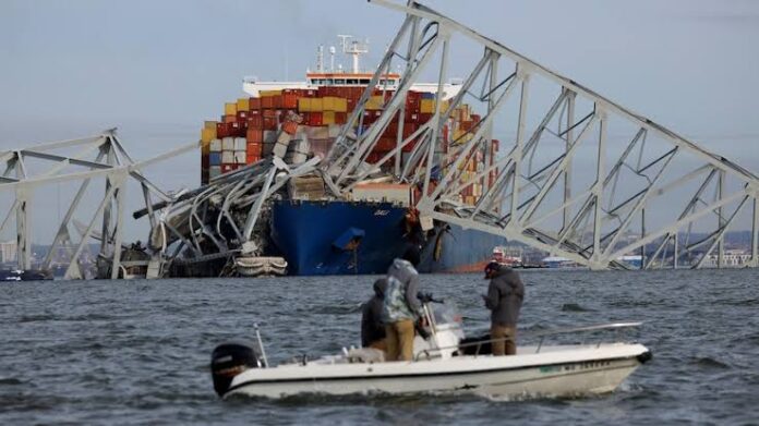 Authorities continue to search for roadworkers who were on a bridge that was brought down by an out-of-control container ship, but say lives were saved by a mayday call from the vessel's crew.