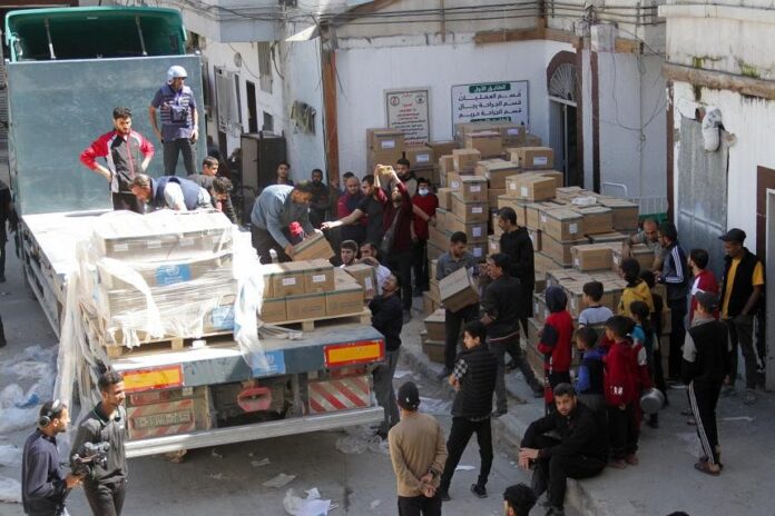 People unload medical aid from a truck, near Kamal Adwan Hospital in the northern Gaza Strip, on April 6, 2024. PHOTO: REUTERS