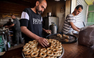 Bakery workers sell kaak, ring-shaped traditional biscuits, as people shop ahead of Eid al-Fitr celebrations which come at the end of the Muslim holy month of Ramadan, in Rafah in the southern Gaza Strip on April 5, 2024, amid the ongoing conflict between Israel and Hamas. (Mohammed Abed/AFP)