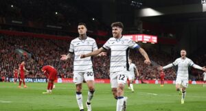 Atalanta’s Italian forward #90 Gianluca Scamacca (L) celebrates scoring the team’s second goal during the UEFA Europa League quarter-final first leg football match between Liverpool and Atalanta at Anfield in Liverpool, north west England on April 11, 2024. (Photo by Darren Staples / AFP)