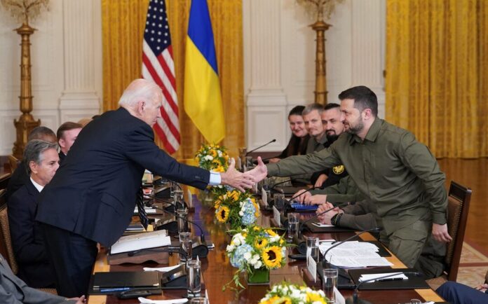 U.S. President Joe Biden and Ukraine President Volodymyr Zelenskiy shake hands across the table during a meeting in the East Room of the White House in Washington, U.S. September 21, 2023