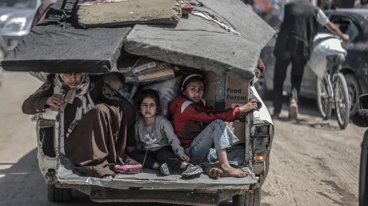 Children sit back on a truck as Palestinians with their packed belongings, continue to depart from the eastern neighborhoods of the city due to ongoing Israeli attacks in Rafah, Gaza on May 8, 2024.  Ali Jadallah | Anadolu | Getty Images