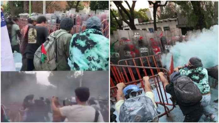 At the embassy, police officers deployed tear gas and threw back the stones hurled at them by protesters. (Screengrab)