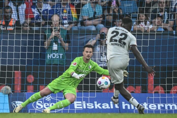 Bayer Leverkusen's Nigerian forward #22 Victor Boniface scores his team’s second goal from the penalty spot past Bochum's goalkeeper #01 Manuel Riemann during the German Bundesliga match in Bochum, Germany yesterday (May 12). — AFP