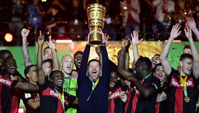 Bayer Leverkusen's Spanish head coach Xabi Alonso celebrates with the trophy after winning the German Cup (DFB-Pokal) final football match between 1 FC Kaiserslautern and Bayer 04 Leverkusen at the Olympic Stadium in Berlin on May 25, 2024. | AFP photo.