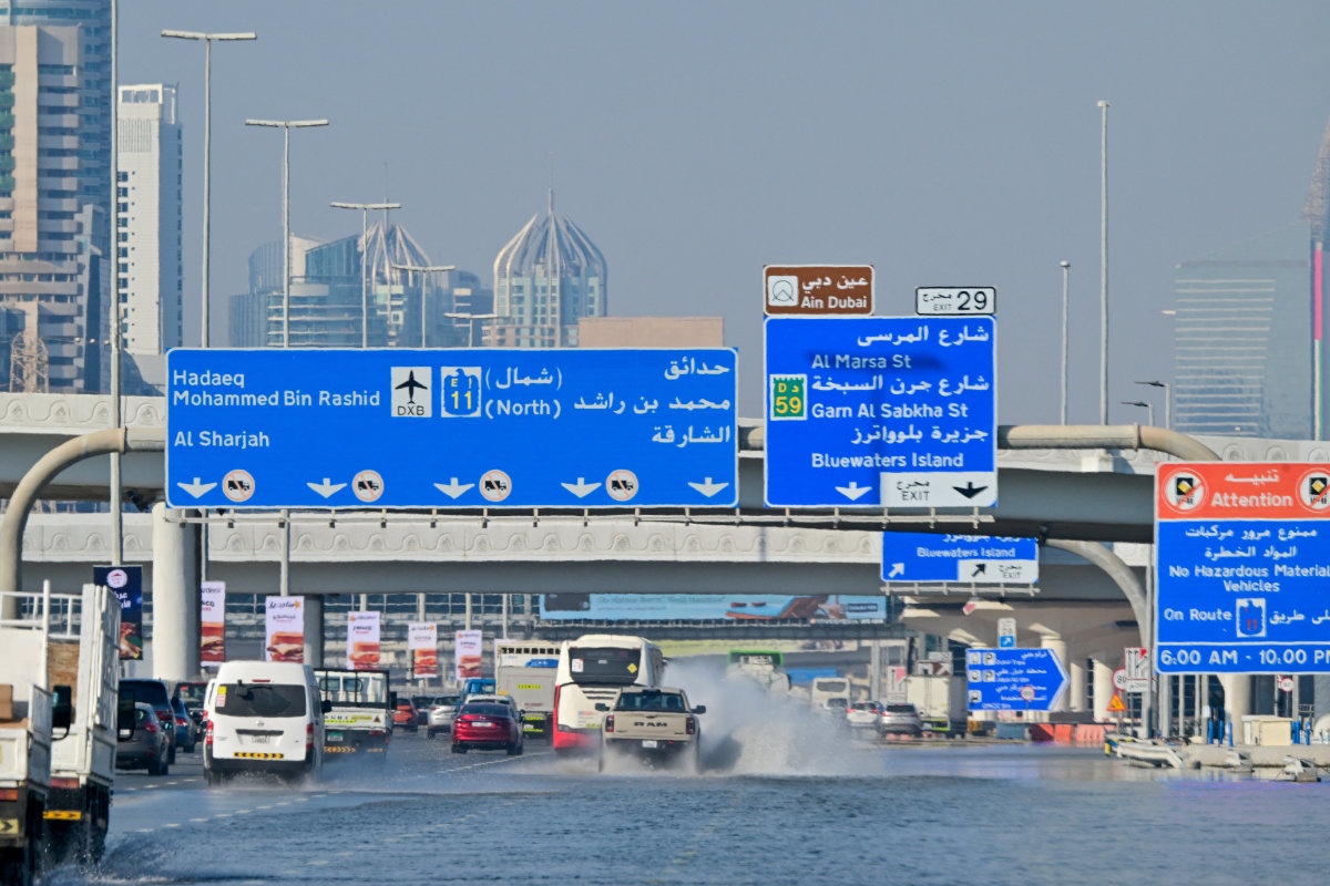 Cars drive down a flooded motorway in Dubai on April 20, 2024. Four people died after the heaviest rainfall on record in the oil-rich UAE on April 16. (AFP)
