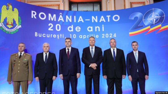 Romanian President Klaus Iohannis (third right) attends a NATO meeting with other Romanian officials.