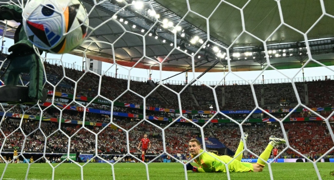 TOPSHOT – Germany’s goalkeeper #01 Manuel Neuer concedes the first goal scored by Switzerland’s forward #19 Dan Ndoye during the UEFA Euro 2024 Group A football match between Switzerland and Germany at the Frankfurt Arena in Frankfurt am Main on June 23, 2024. (Photo by Angelos Tzortzinis / AFP)