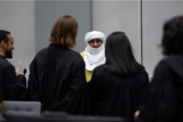 Al Hassan Ag Abdoul Aziz Ag Mohamed Ag Mahmoud talks to his defence counsel in the courtroom of the International Criminal Court in The Hague, Netherlands, Wednesday, June 26, 2024, where judges deliver the verdict in the trial of the suspect accused of playing a key role in a reign of terror unleashed by Al-Qaida-linked insurgents on the historic desert city of Timbuktu in northern Mali in 2012. Peter Dejong/Pool via REUTERS