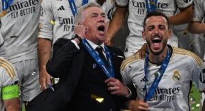 Real Madrid’s Italian coach Carlo Ancelotti (C) celebrates with his medal after winning the UEFA Champions League final football match between Borussia Dortmund and Real Madrid, at Wembley Stadium, in London, on June 1, 2024. (Photo by Paul ELLIS / AFP)