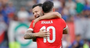 Switzerland’s midfielder #10 Granit Xhaka celebrates with Switzerland’s midfielder #11 Renato Steffen at the end of the UEFA Euro 2024 round of 16 football match between Switzerland and Italy at the Olympiastadion Berlin in Berlin on June 29, 2024. (Photo by AXEL HEIMKEN / AFP)