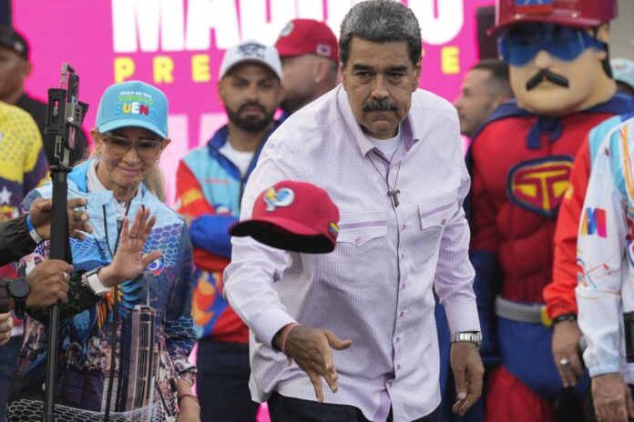 Venezuelan President Nicolas Maduro throws a cap to supporters during a campaign rally in the Boulevard of Coche in Caracas, Venezuela, Monday, July 8, 2024. Ariana Cubillos - staff, ASSOCIATED PRESS