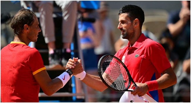 Winner, Serbia’s Novak Djokovic (R) shakes hands with Spain’s Rafael Nadal (L) after their men’s singles second round tennis match on Court Philippe-Chatrier at the Roland-Garros Stadium at the Paris 2024 Olympic Games, in Paris on July 29, 2024. (Photo by Martin BERNETTI / AFP)