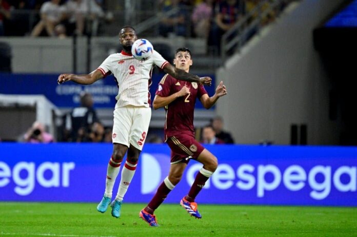 Canada forward Cyle Larin (9) and Venezuela defender Nahuel Ferraresi (2) leap for the ball during the second half in the 2024 Copa America quarterfinal at AT&T Stadium. -- Pic by Jerome Miron-USA TODAY Sports