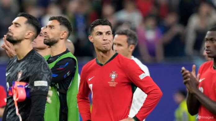Portugal's Cristiano Ronaldo reacts after losing a quarter final match between Portugal and France at the Euro 2024 soccer tournament in Hamburg, Germany, Friday, July 5, 2024. France won a penalty shoot out 4-3 after the match ended in a 0-0 draw. (AP Photo/Martin Meissner)