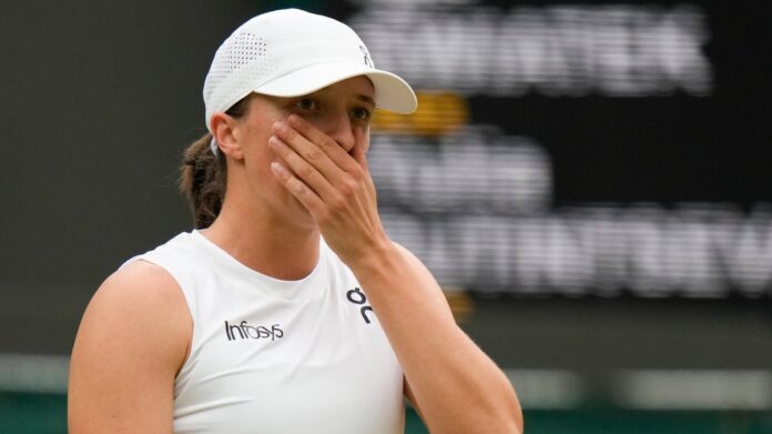 Iga Swiatek of Poland reacts during her third round loss to Yulia Putintseva of Kazakhstan at the Wimbledon tennis championships in London, Saturday, July 6, 2024. AP