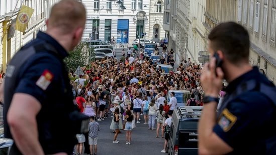 Austria-Taylor-Swift-18_1723196122224_1723196151745 Austrian police officers watch swifts gathering in the city centre in Vienna on Thursday, Aug.8, 2024. Organizers of three Taylor Swift concerts in the stadium in Vienna this week called them off on Wednesday after officials announced arrests over an apparent plot to launch an attack on an event in the Vienna area such as the concerts. (AP Photo/Heinz-Peter Bader)(AP)