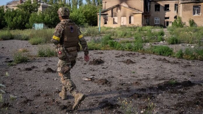 A serviceman of 24th Mechanized brigade named after King Danylo of the Ukrainian Armed Forces walks down a street, amid Russia’s attack on Ukraine, near the frontline town of Chasiv Yar in Donetsk region, Ukraine, June 27, 2024. (Reuters)