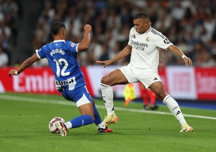 Real Madrid’s Kylian Mbappe in action with Deportivo Alaves’ Santiago Mourino at the Santiago Bernebeu stadium on September 24, 2024 | Photo Credit: Reuters